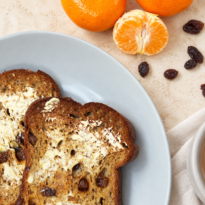 Buttered toasted SRSLY low carb fruit bread served with orange