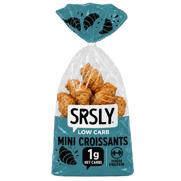 A bag of SRSLY Low Carb Mini Croissants on a clean white background. The product is packaged in a clear plastic bag with a teal and white label, showing the golden-brown baked mini croissants inside.