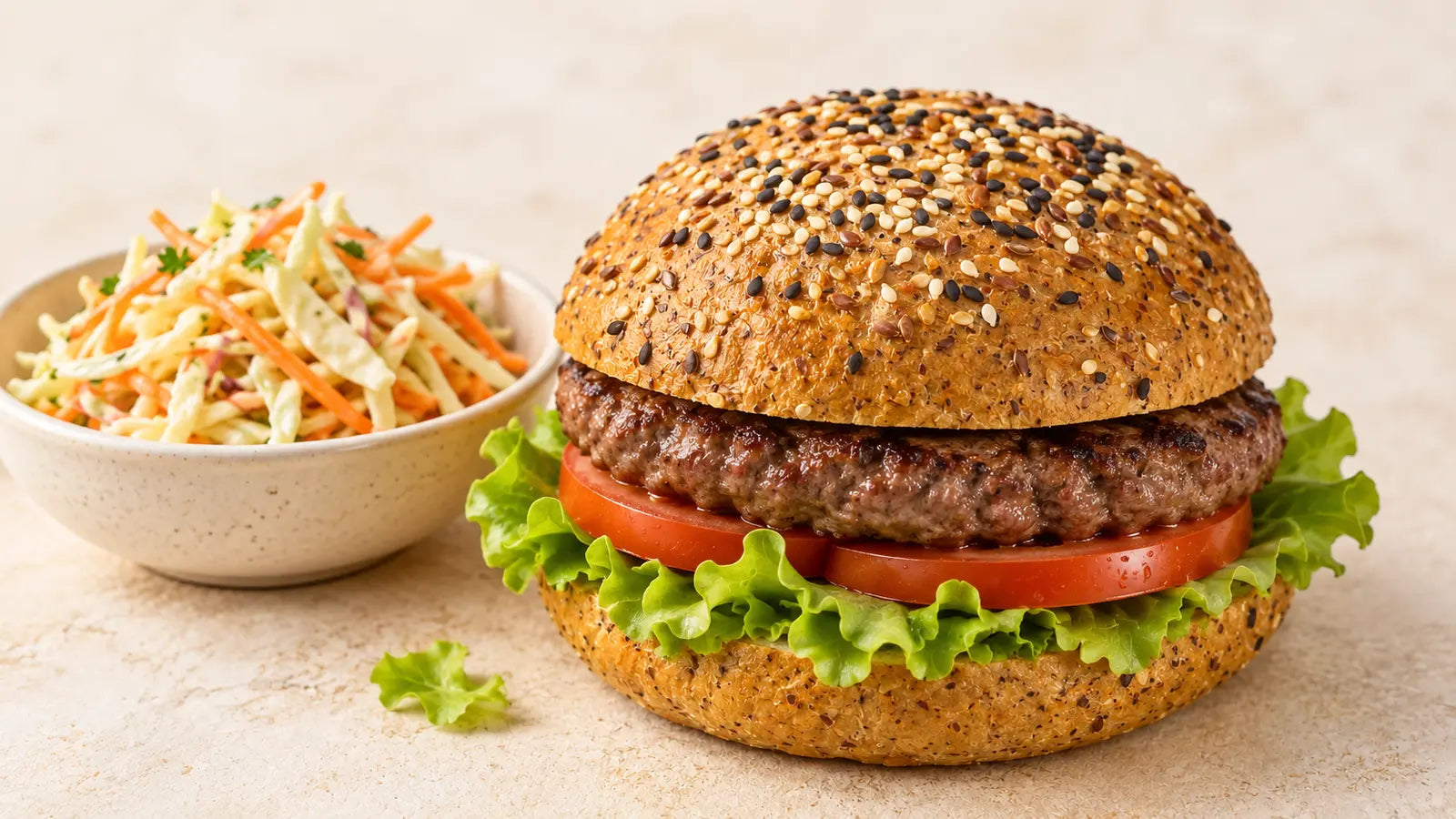 Beef burger with tomato in an SRSLY seeded roll served with cabbage and carrot slaw